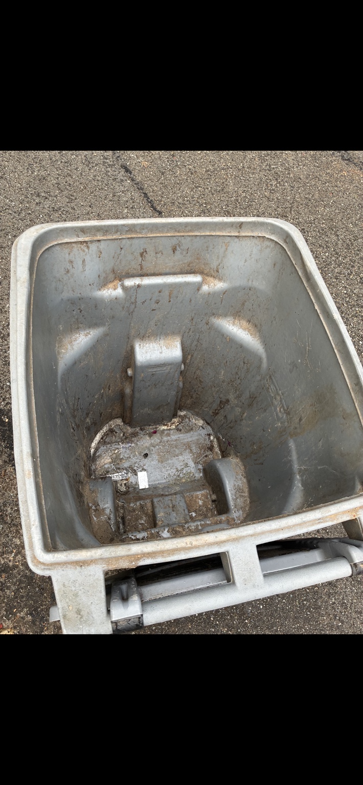 Inside of a dirty trash bin before cleaning