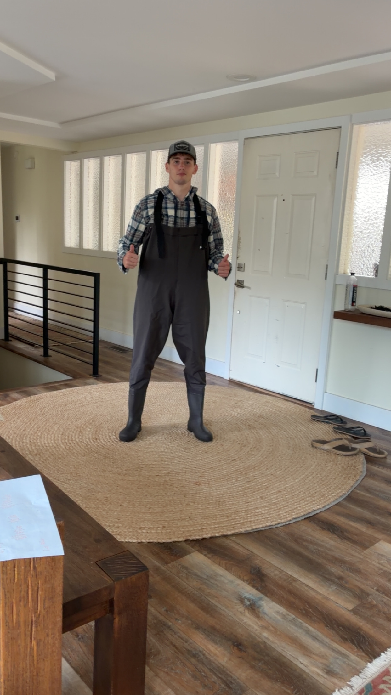 Carson, owner of Bellevue Premiere Wash, wearing work overalls and giving two thumbs up